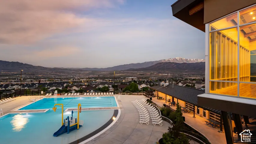 HOA Amenities Expansive outdoor pool area featuring a multi-lane swimming pool and a shallow water play structure