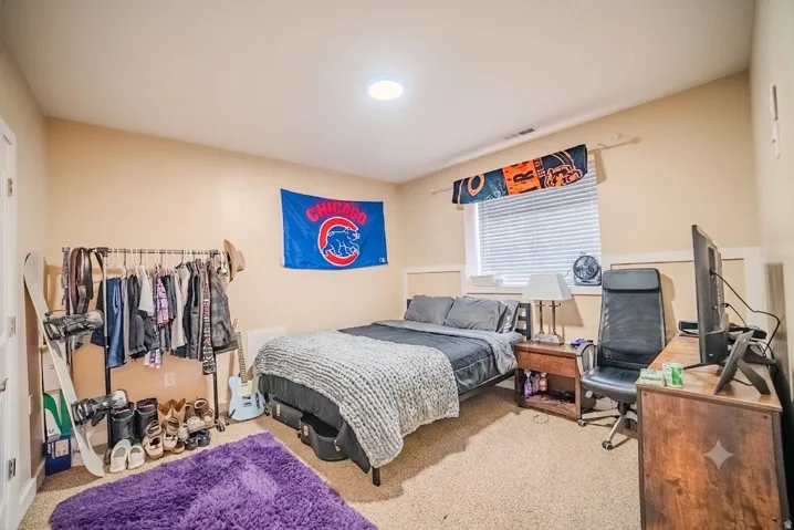 Bedroom featuring neutral-toned walls and carpeted flooring