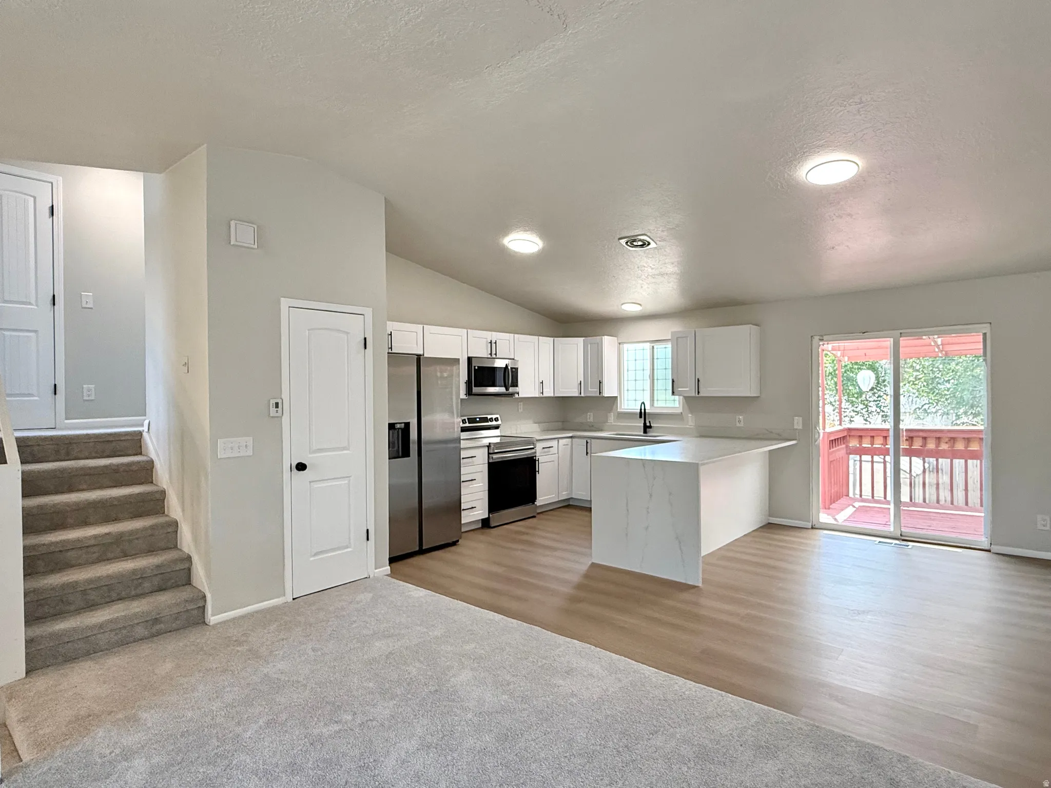 Open-concept living space with vaulted ceilings