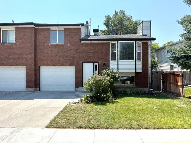 Brick exterior with white siding accents and a prominent bay window