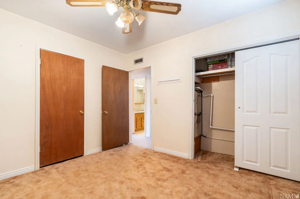 Room featuring neutral-toned walls and plush carpeting