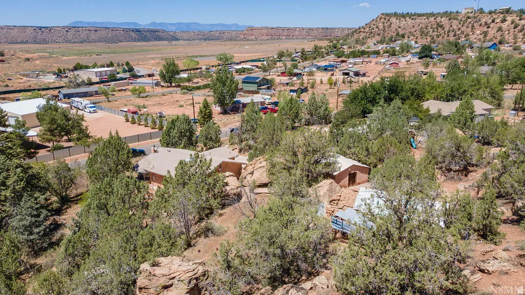 Expansive property featuring natural landscaping, mature trees, and rock formations