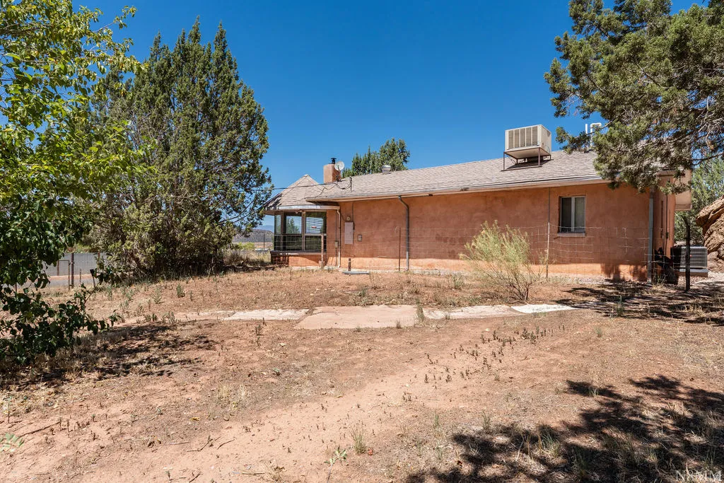 Brick residential home with single-story construction featuring a side-entry design and flat roofline