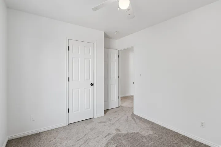 Neutral-toned carpeting complements white walls in this interior space