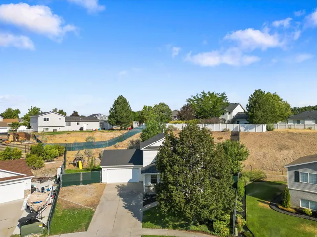Modern home situated on expansive grounds featuring a clean contemporary design with dark exterior trim and white siding