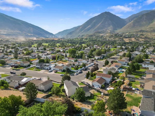 Aerial perspective showcasing a residential community nestled at the base of mountains