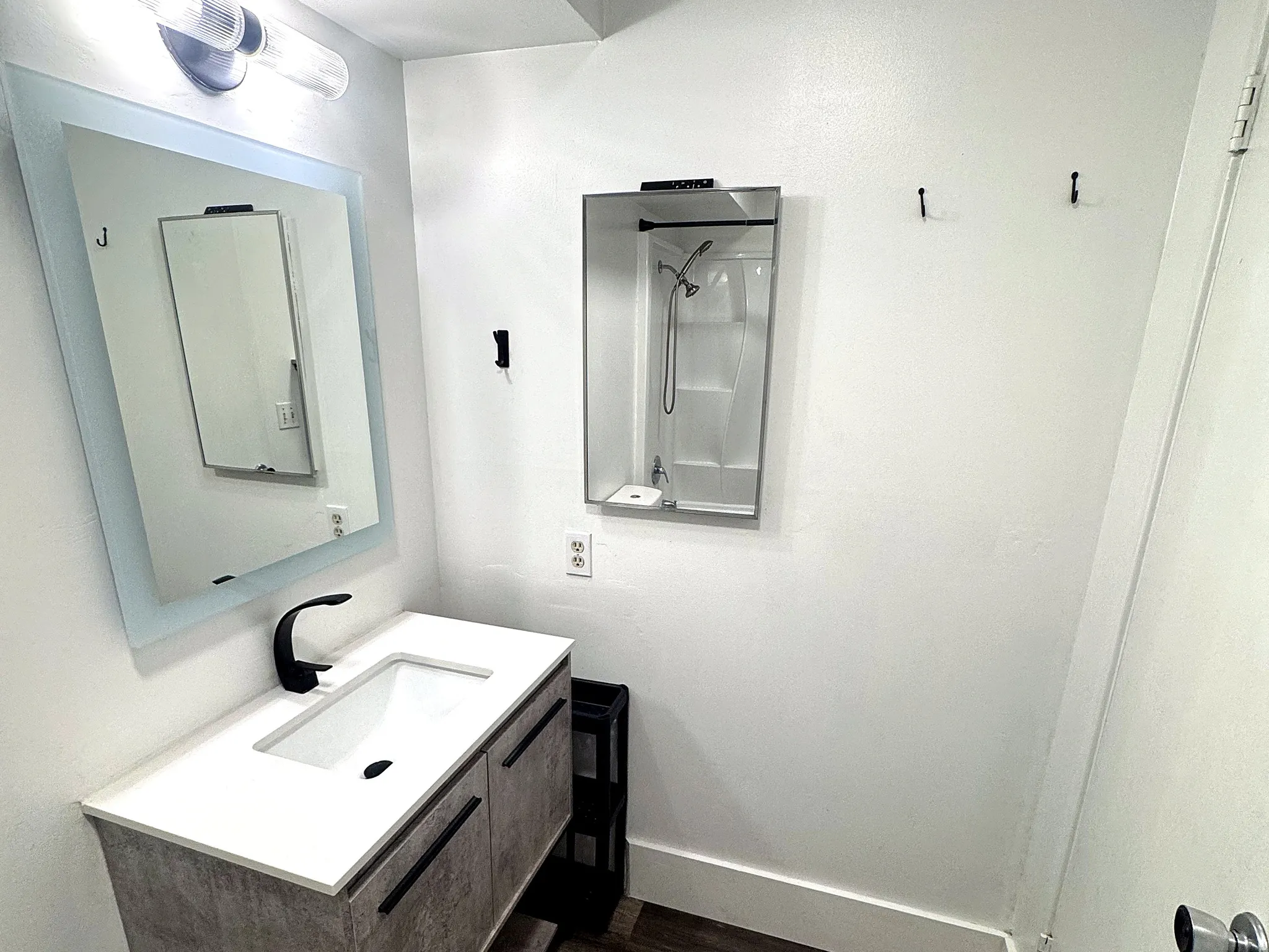 Contemporary vanity with a white countertop and integrated sink