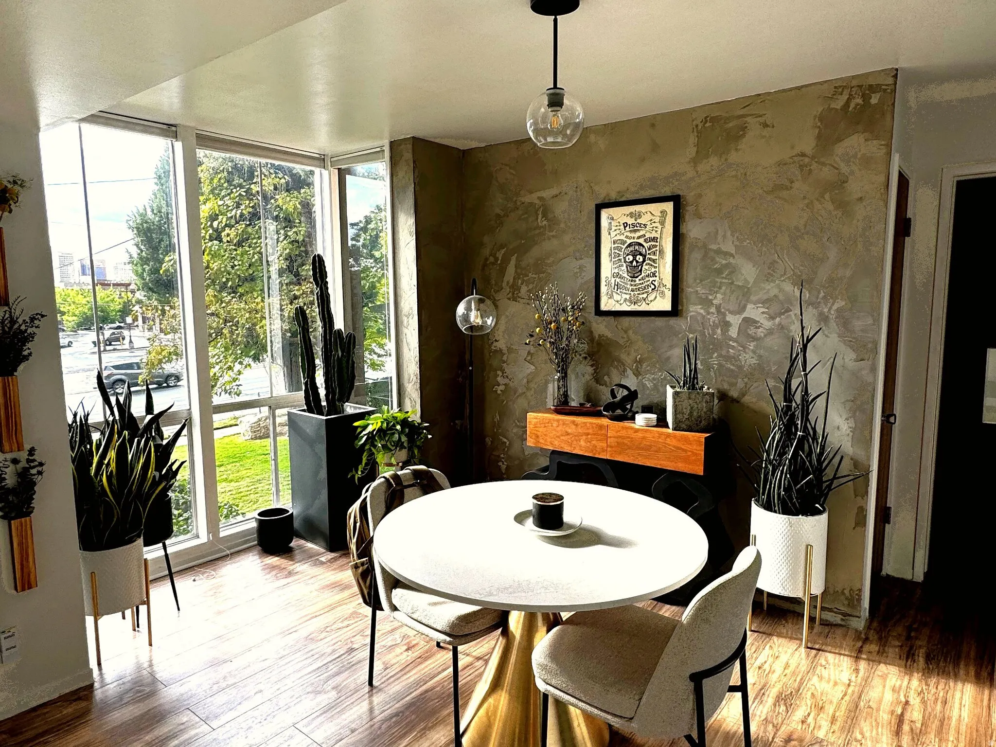 Dining area with wood-finish flooring and large windows