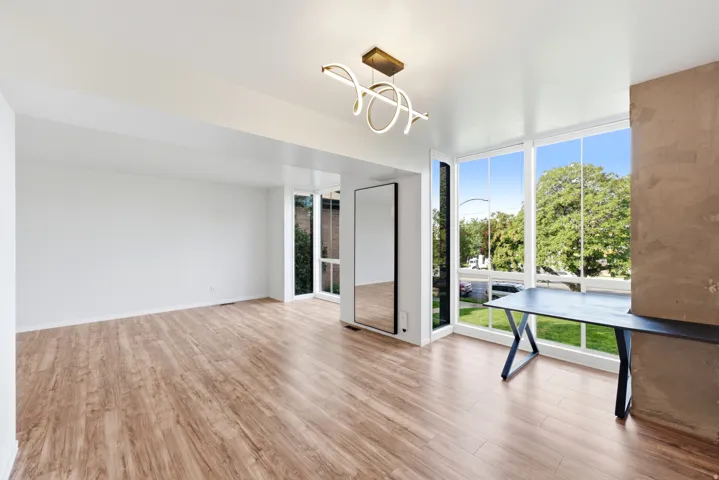 Wood-finish flooring throughout, complemented by expansive windows offering abundant natural light