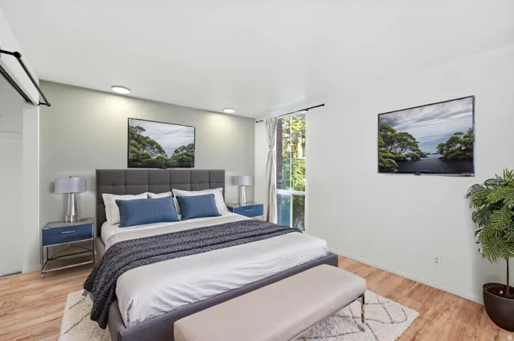 Wood-finish flooring, recessed lighting, and a window with exterior tree scenery