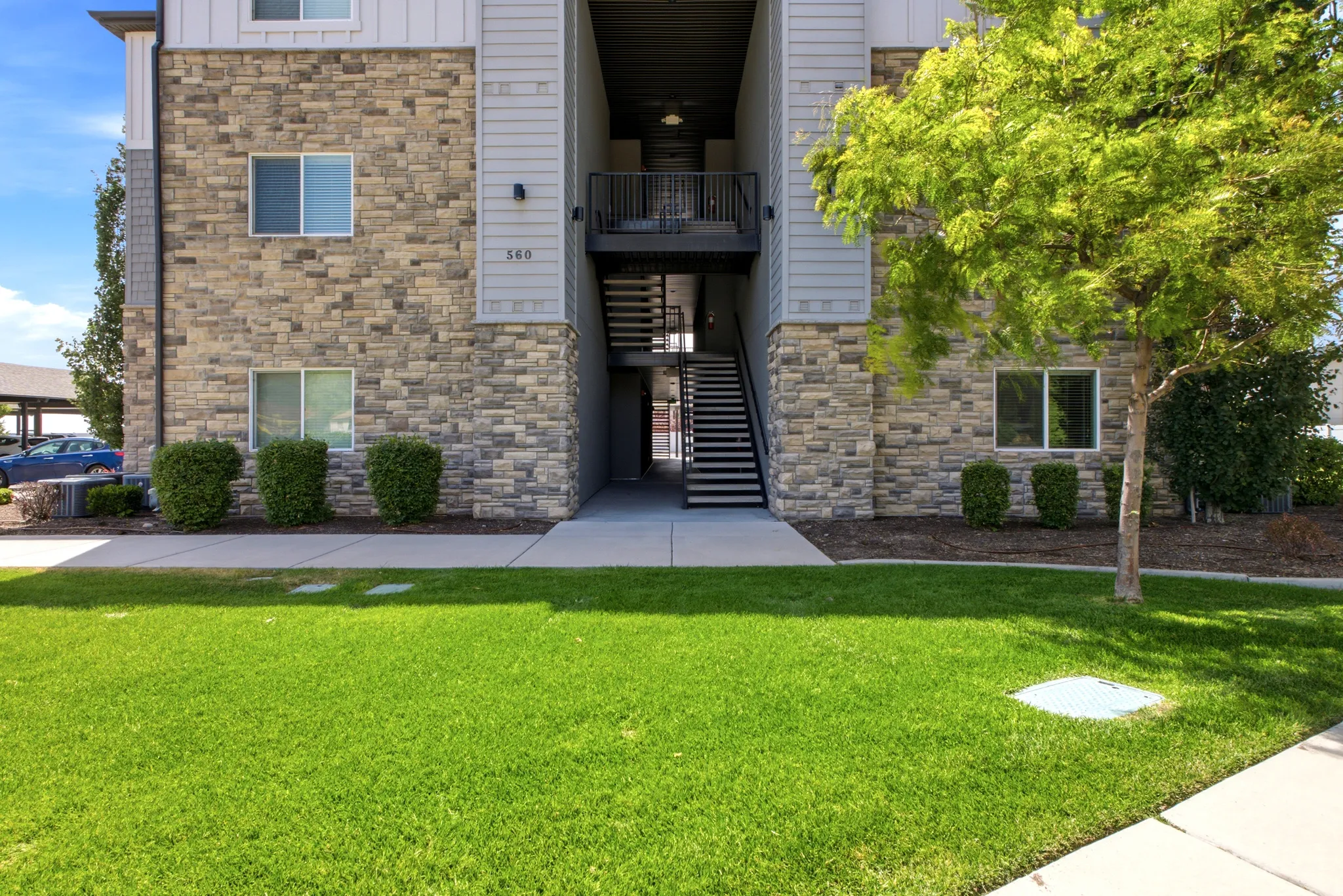 Exterior facade featuring stone veneer and horizontal siding