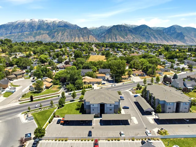 Contemporary multi-story buildings featuring neutral siding and gray roofing