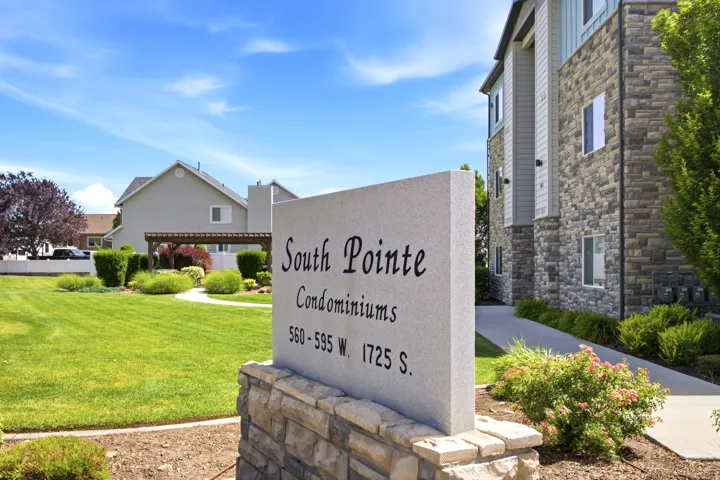 South Pointe Condominiums entrance sign featuring a stone base and a granite-look plaque