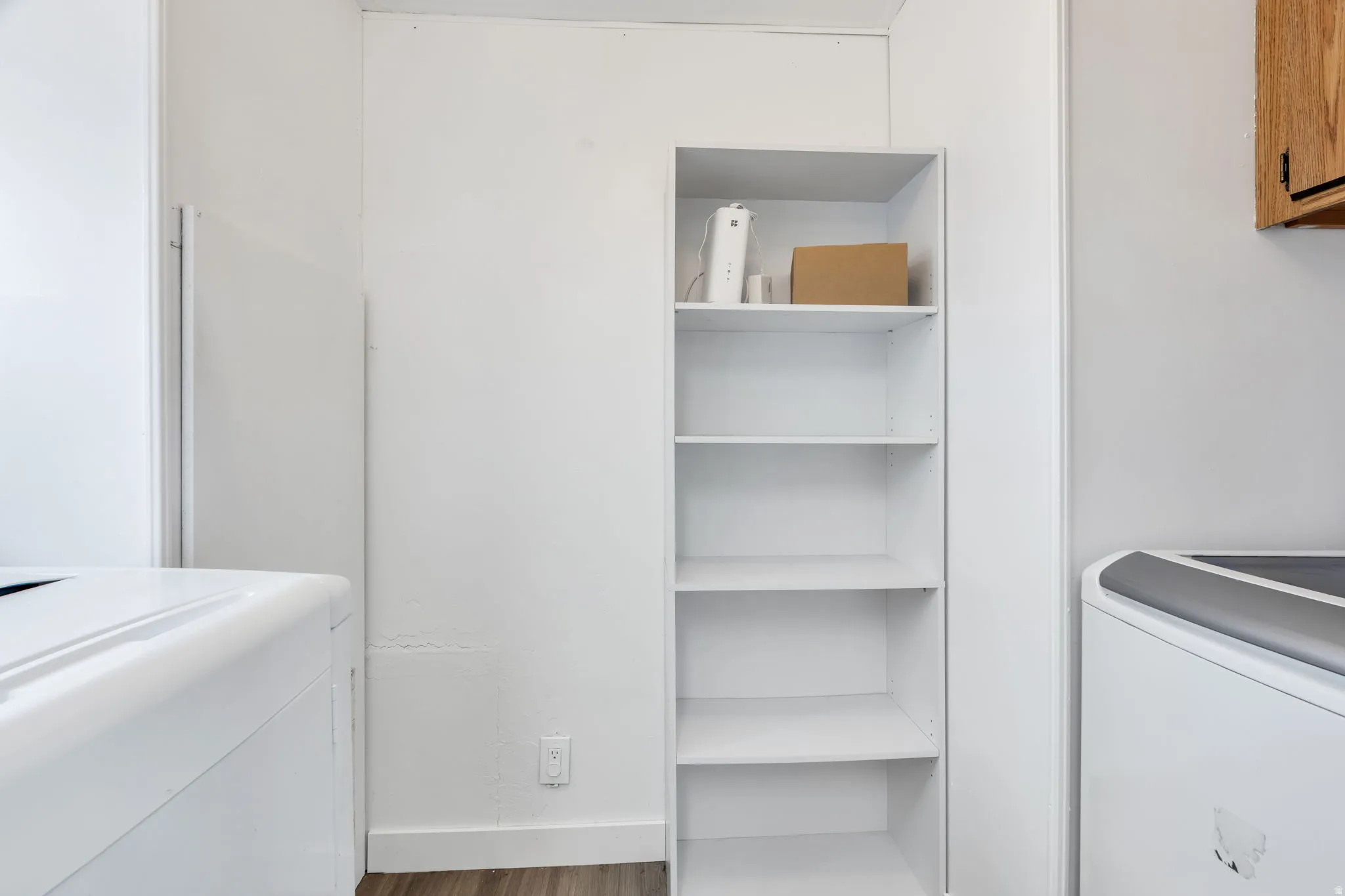 Built-in shelving unit with five white shelves