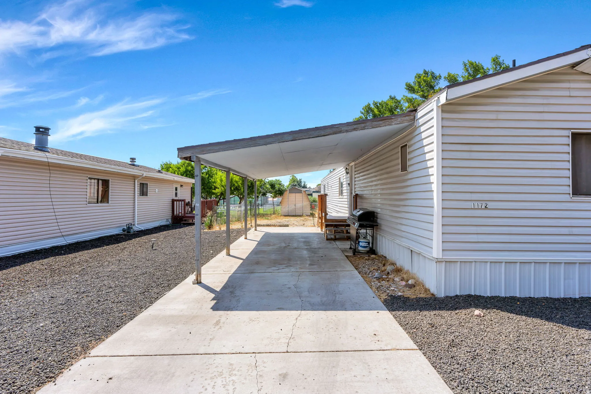 Covered carport with a concrete driveway