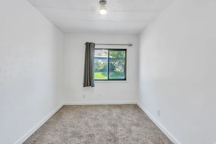 Recessed window with dark framing and a single ceiling light fixture