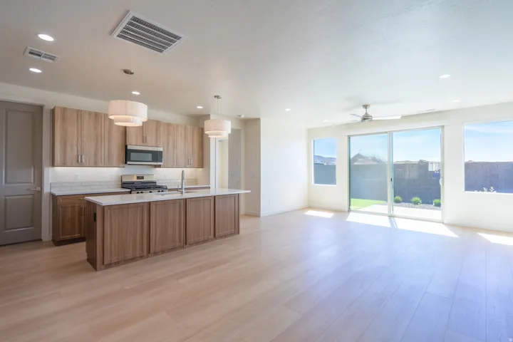 Open concept living area with light wood-finish flooring