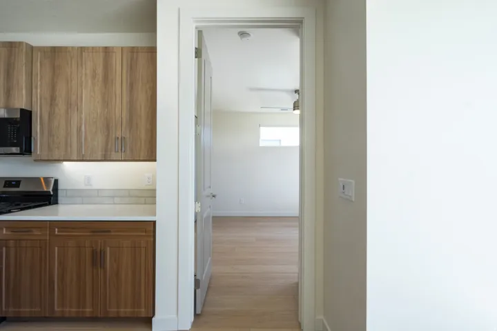 Kitchen featuring wood-finish cabinetry, white countertops, and a subway tile backsplash