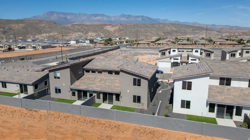 Contemporary multi-story residences featuring stucco exteriors and distinct rooflines, each with private backyard spaces