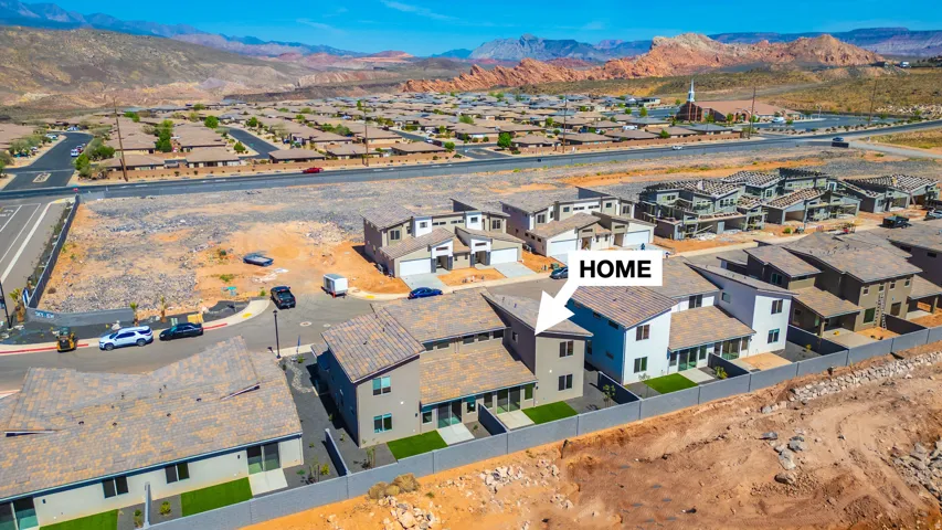Modern two-story residence featuring a neutral exterior, tile roofing, and a privacy fence