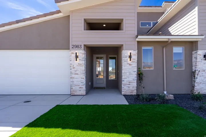 Contemporary exterior featuring a stucco and siding facade with stone accents