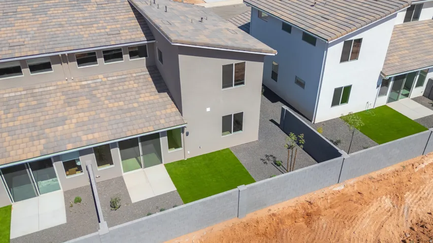 Modern residential architecture with stucco exteriors and multi-toned tile roofs