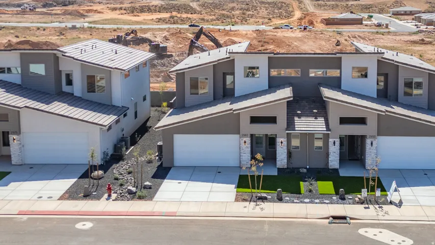 Contemporary-style duplex featuring stone accents and a unique roofline