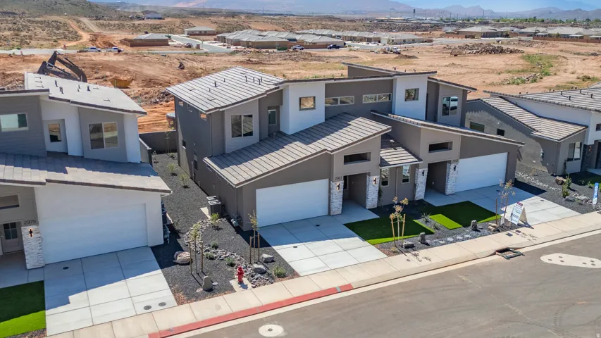Contemporary residences featuring sloped roofs, two-car garages, and stone facade accents