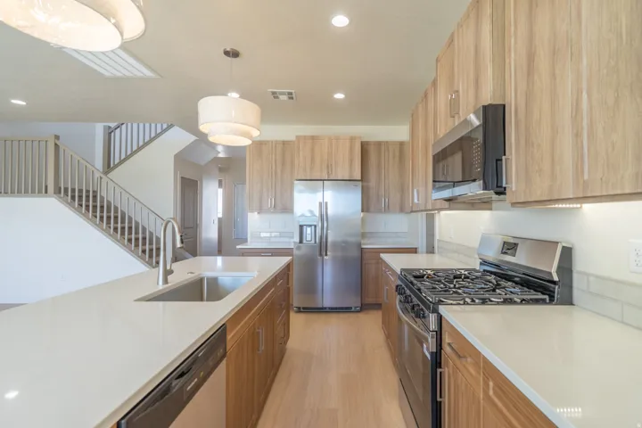 Modern kitchen featuring light wood-finish cabinetry and light wood-finish flooring