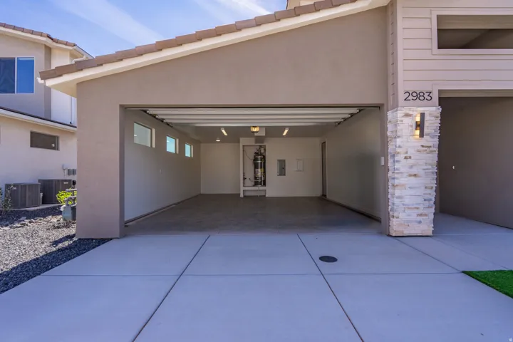 Two-car garage featuring a concrete floor, multiple windows for natural light, and recessed lighting