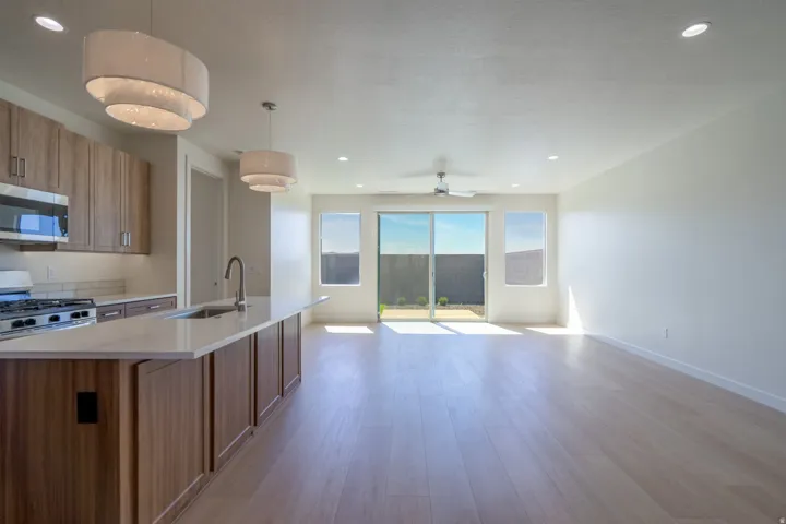 Open-concept space featuring light wood-finish flooring and recessed lighting
