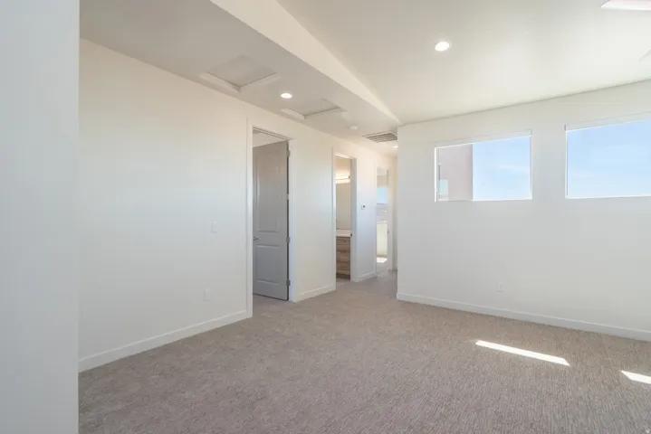 Spacious interior featuring neutral carpeting and white walls