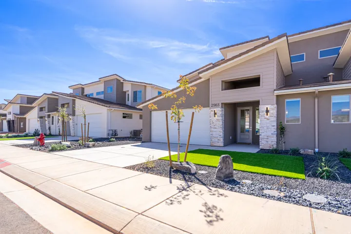 Contemporary architectural design featuring a neutral stucco and siding exterior