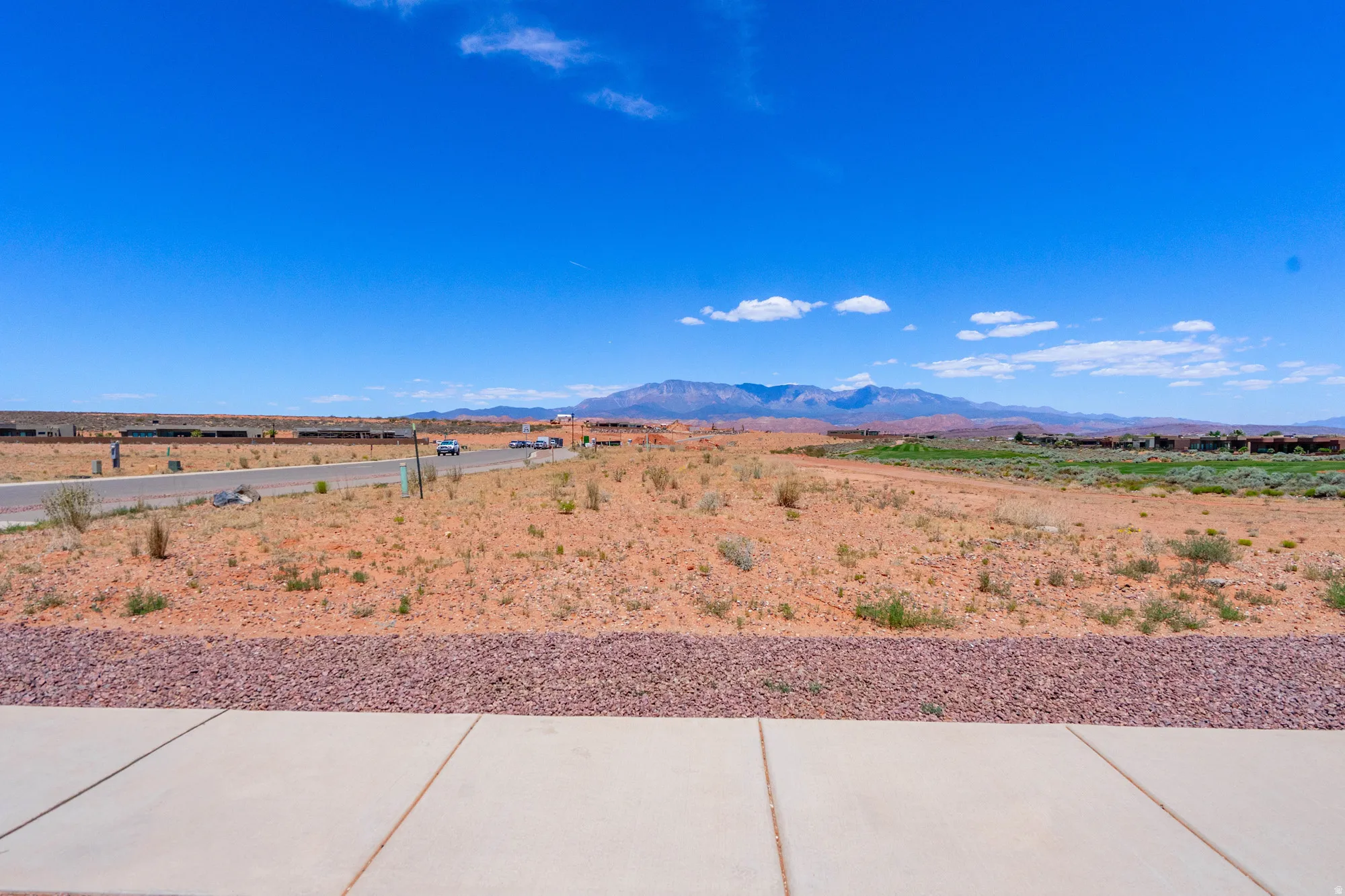 Expansive vacant land with clear sightlines across the property and distant mountain backdrop