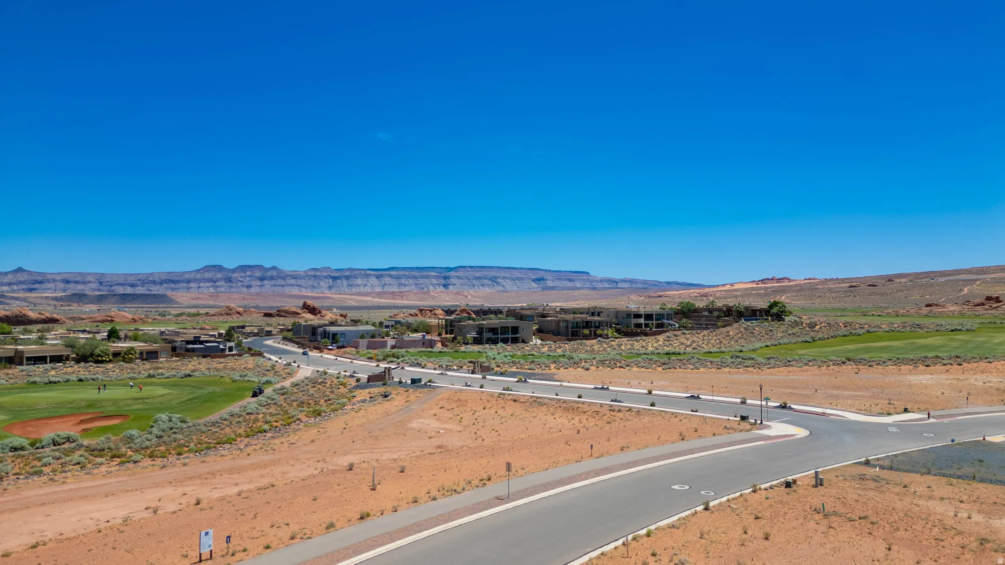 Expansive raw land parcel featuring newly constructed asphalt roadway with professional grading and site preparation