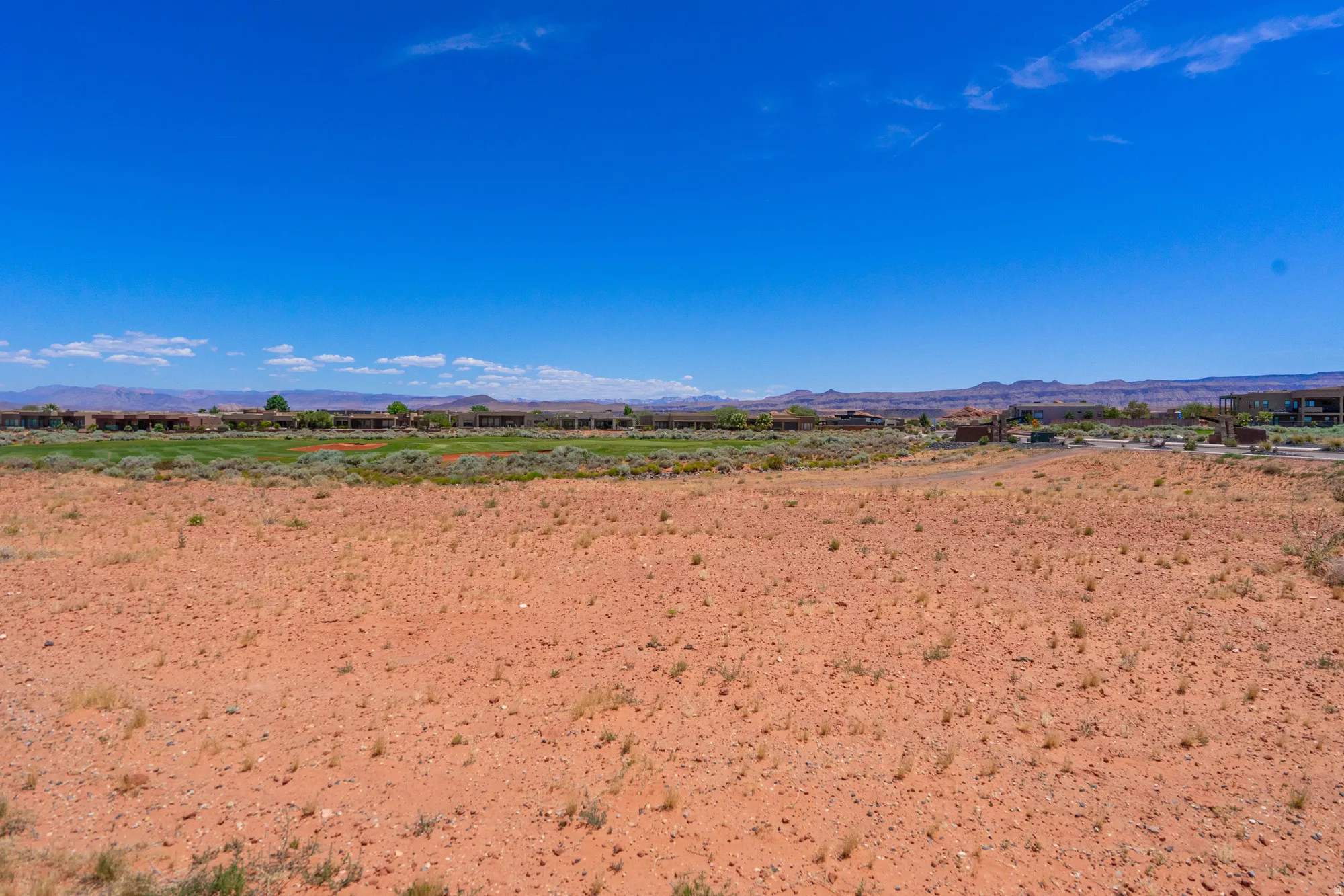 Expansive vacant land featuring rich, reddish-brown soil with excellent drainage characteristics