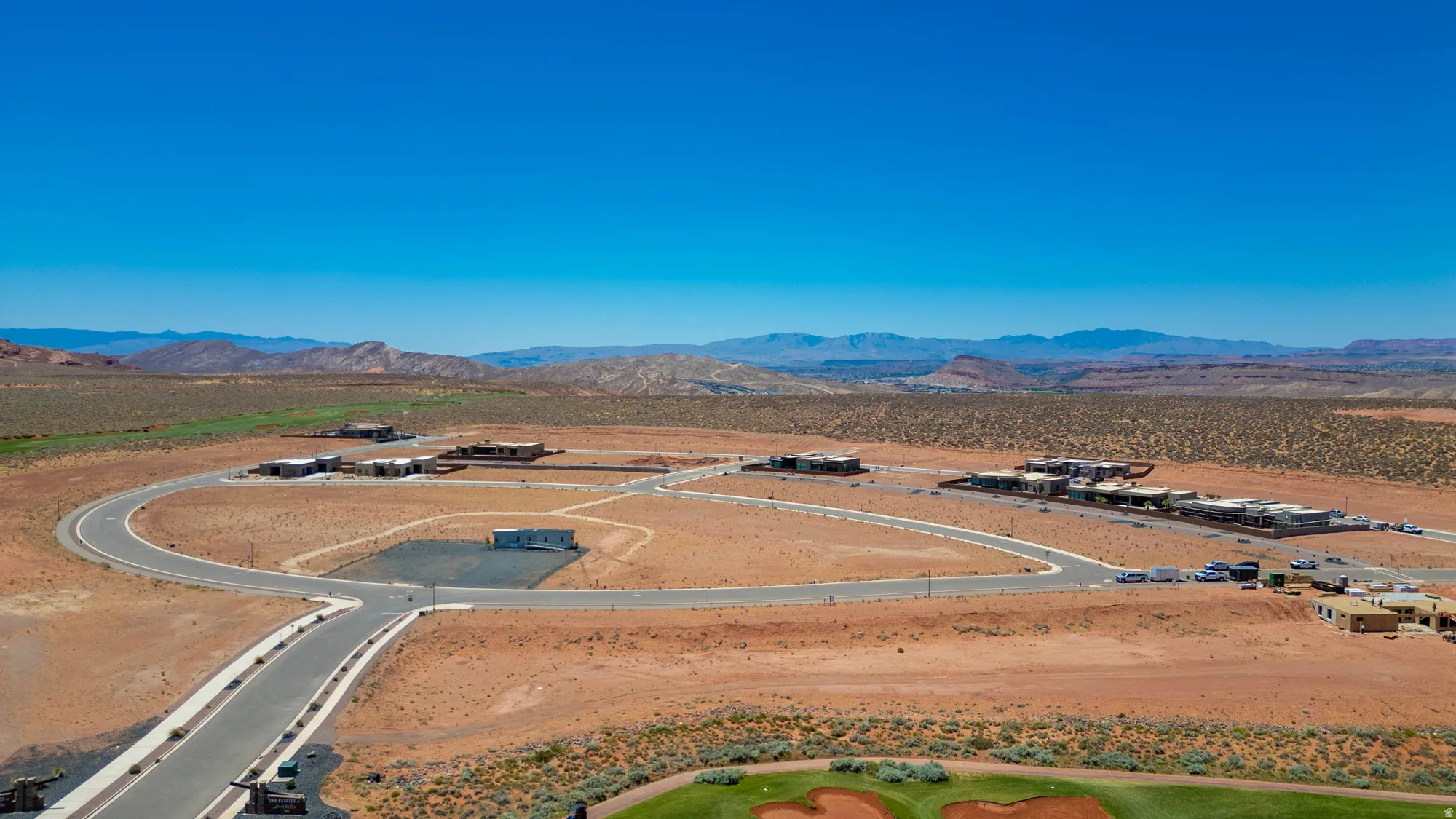 Aerial view of this expansive property showcasing a distinctive circular design with modern infrastructure, paved access roads, and manicured grounds