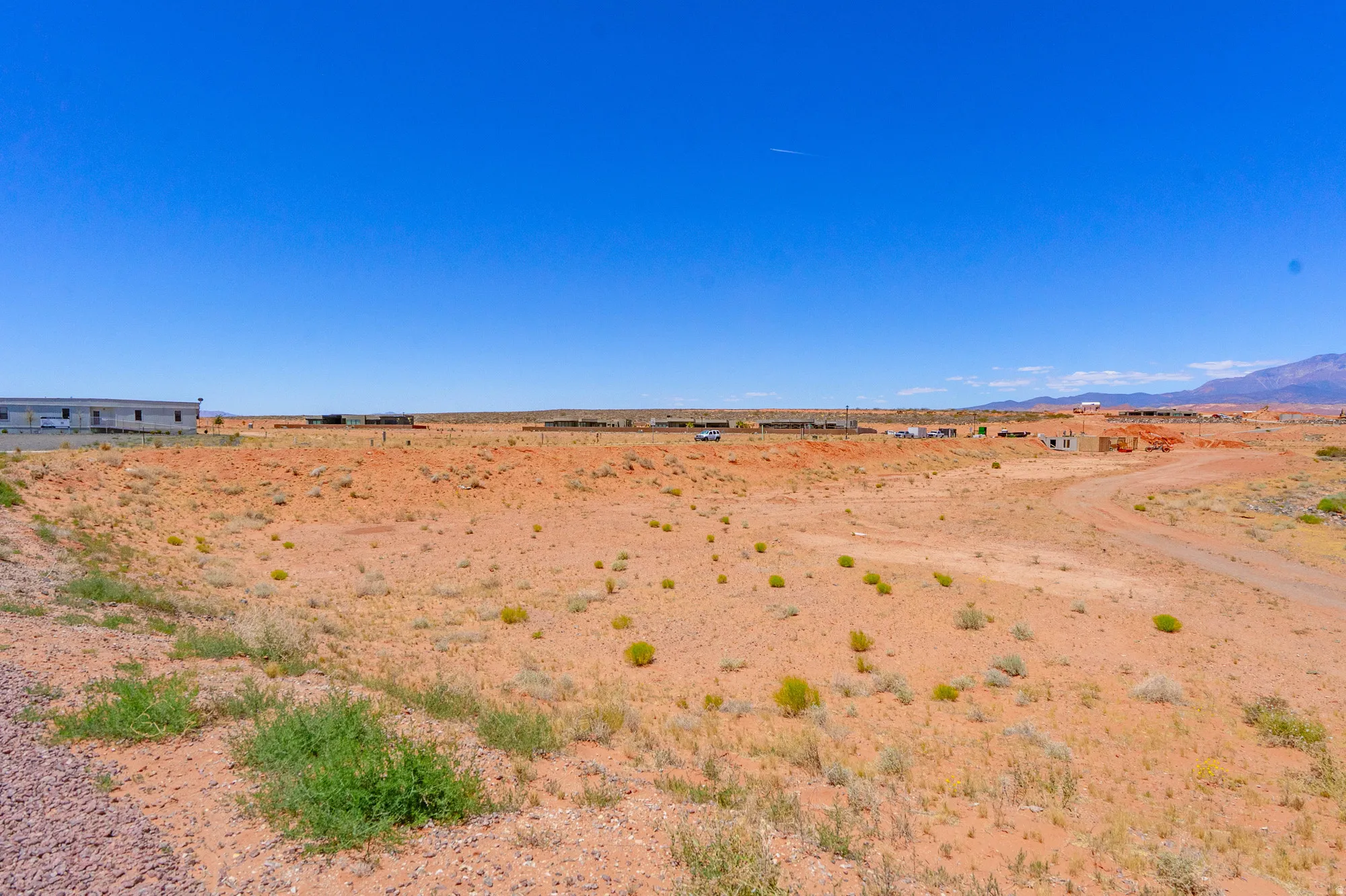 Expansive desert lot with natural, undulating terrain and sparse native vegetation