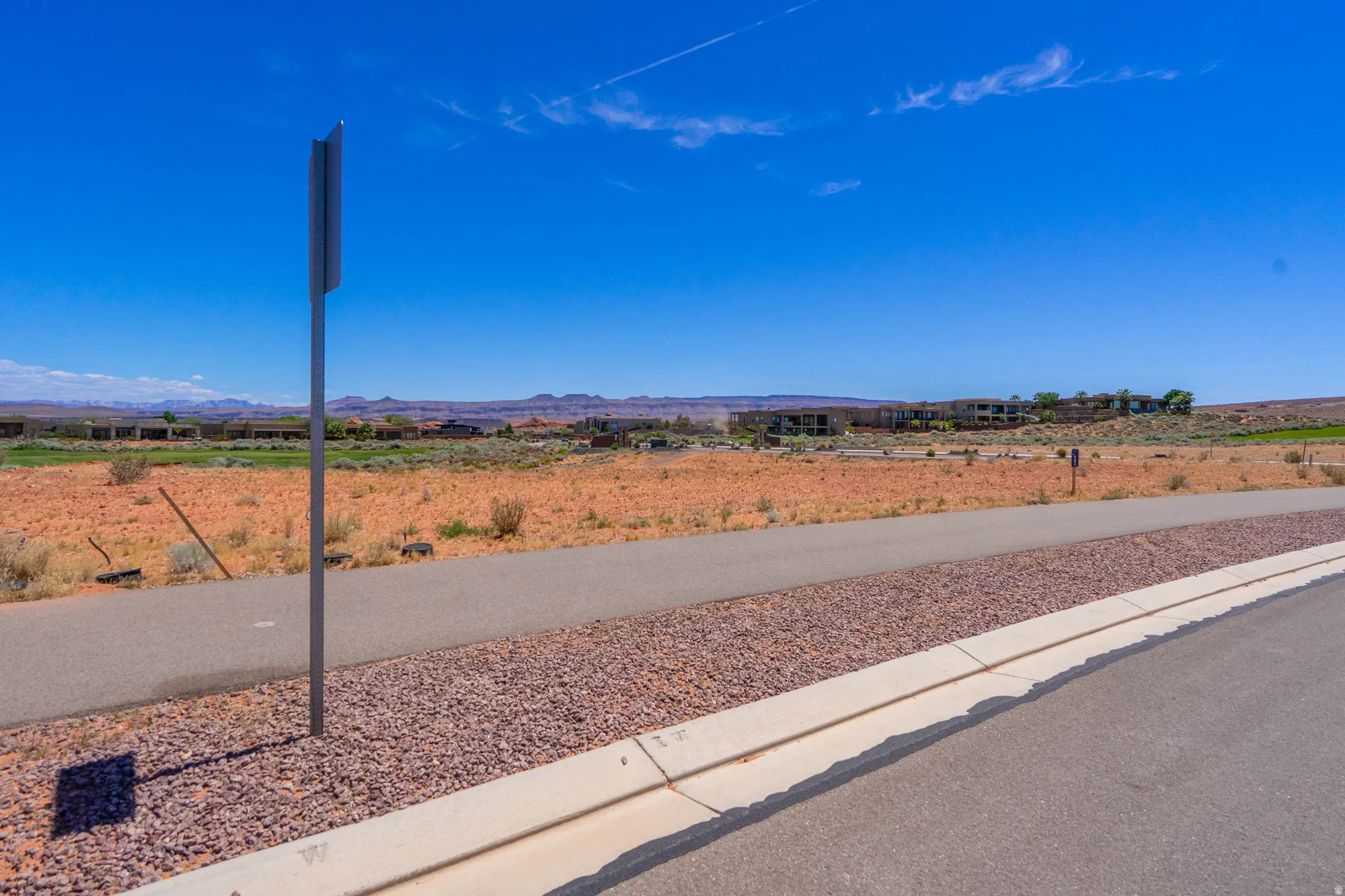 Vacant land lot featuring newly poured concrete foundation and utility infrastructure