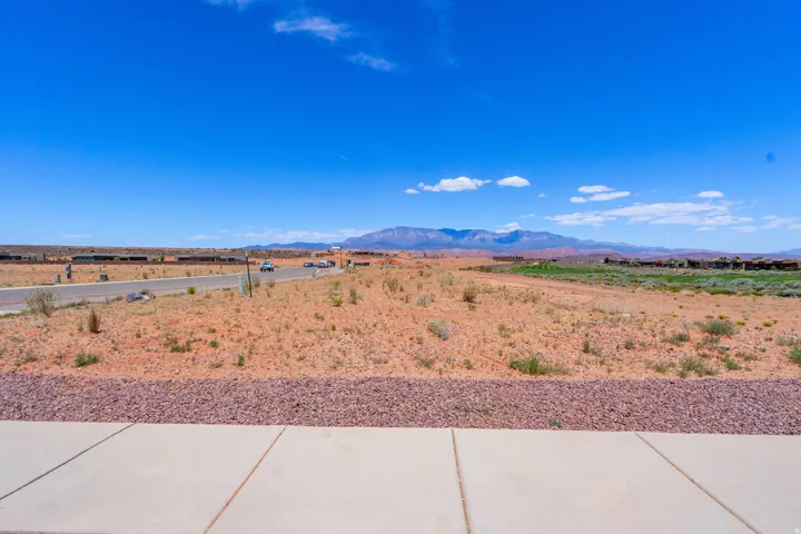 Expansive vacant land with clear sightlines across the property and distant mountain backdrop