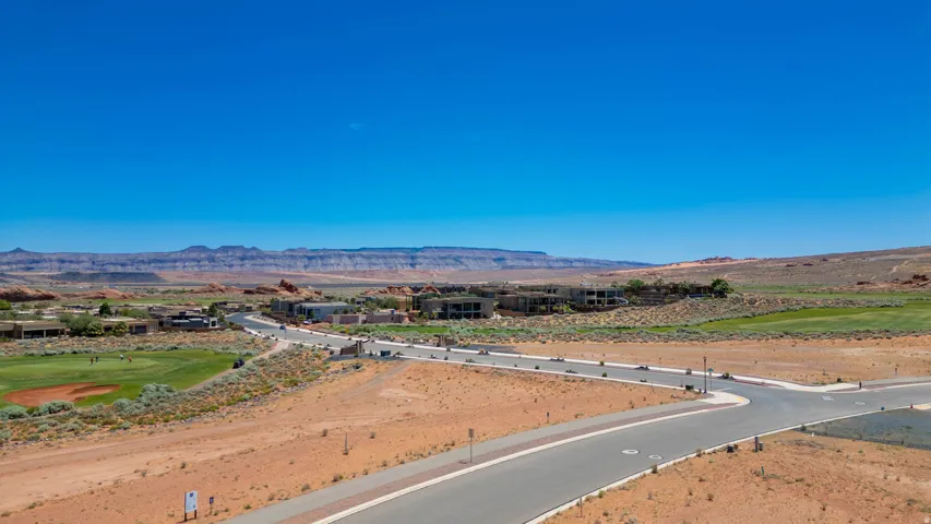 Expansive raw land parcel featuring newly constructed asphalt roadway with professional grading and site preparation