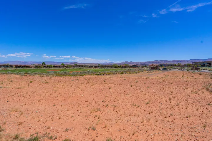 Expansive vacant land featuring rich, reddish-brown soil with excellent drainage characteristics