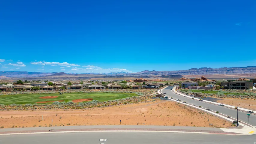 Expansive property with panoramic vistas of verdant agricultural lands and distant mountain ranges
