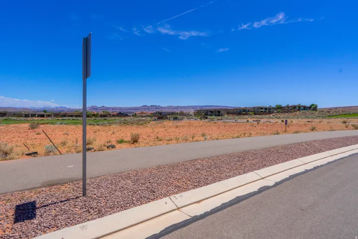Vacant land lot featuring newly poured concrete foundation and utility infrastructure