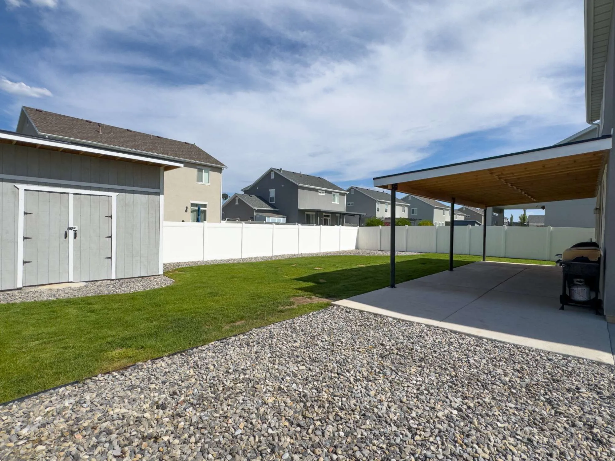 Expansive backyard featuring a covered patio