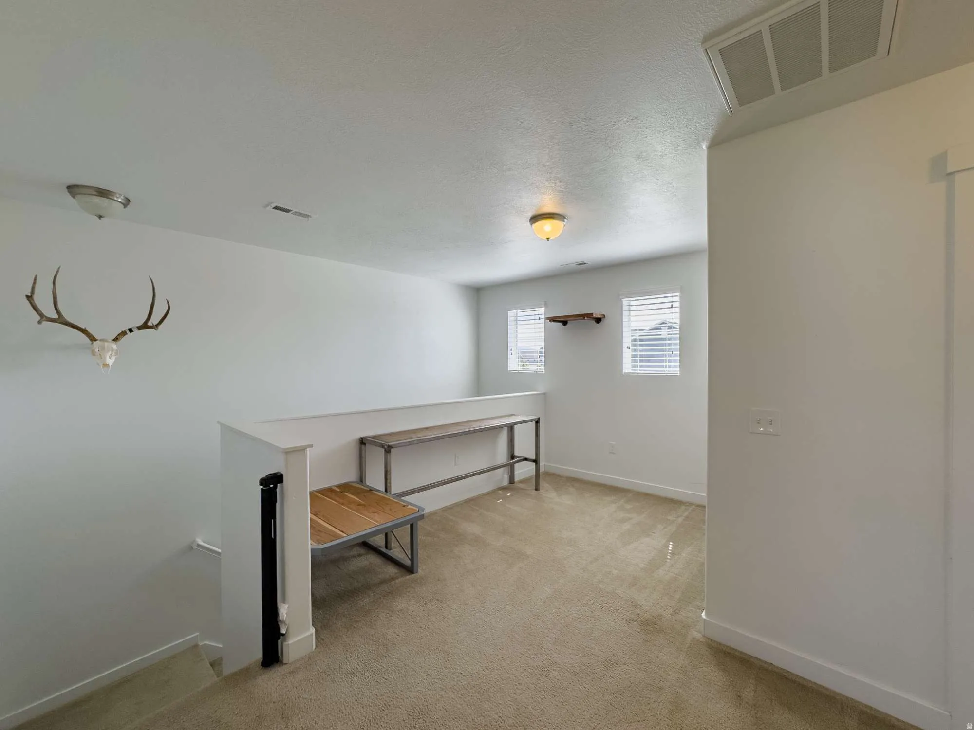 Landing at top of stairs. Could be used as play area or office nook.
