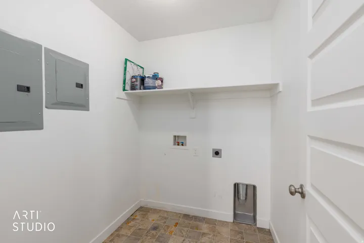 Utility space with durable vinyl flooring and a single floating shelf