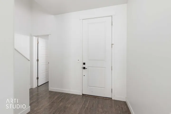 Front entry showing entry to half bath on left, and laminate flooring.