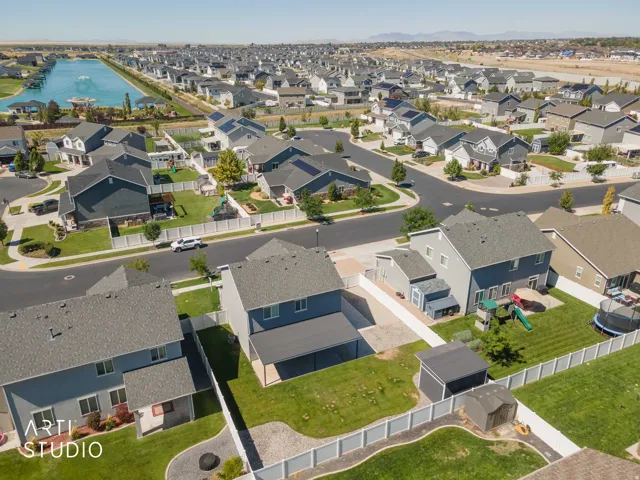 Expansive neighborhood with a large aquatic feature, paved streets, and a mix of single-family residences