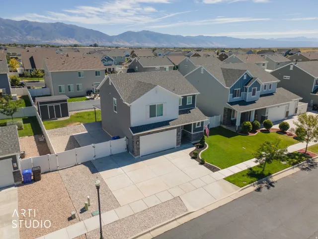 Two-story home with a two-car garage, concrete driveway, and a fenced backyard